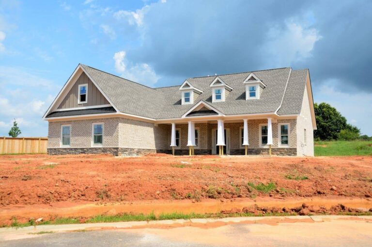 Image of new house sitting on unlandscaped yard.